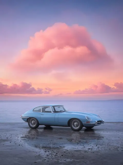 Minimalist Vintage Sports Car Under Pink Clouds