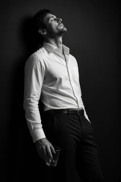 Black and White Profile of Man Holding Glass