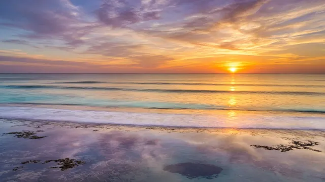 Glassy Sunset Swells Across a Flat Coral Reef