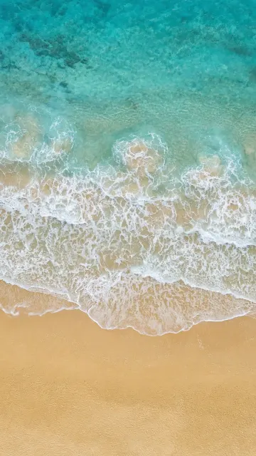 Drone Aerial of Intricate Foam Filigree on Golden Beach