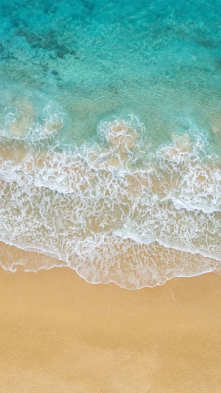 Drone Aerial of Intricate Foam Filigree on Golden Beach