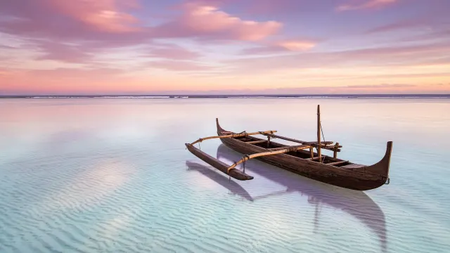 Dawn Reflections Across Aitutaki Barrier Lagoon with Lone Moored Outrigger Canoe