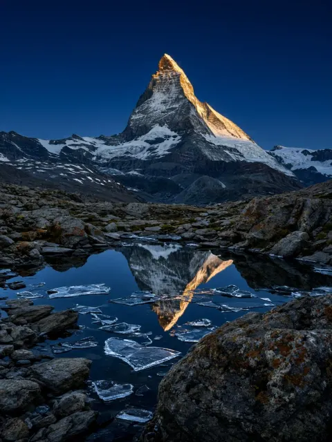 Alpine Solitude and Frozen Tarn Beneath the Matterhorn