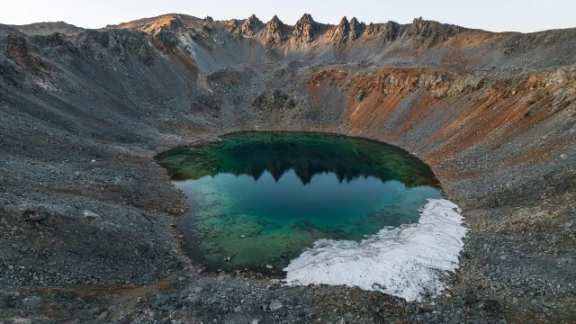 Aerial Angle on an Emerald Cirque Tarn and Scree Slopes