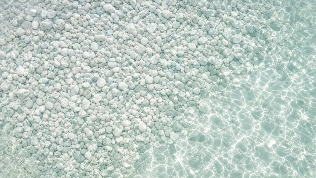 Shallow Clear Tide Pool over Smooth White Quartz Pebbles