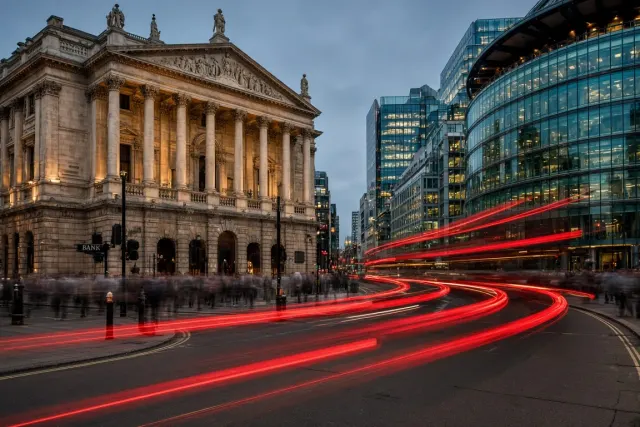 Streaking Red Transit Trails Past Classical Porticos and Curved Glass
