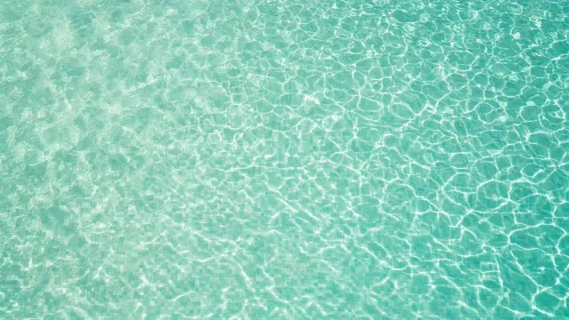Overhead Serene Swimming Pool Water Ripple Texture