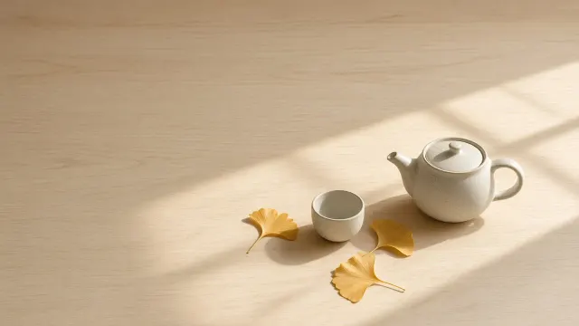 Zen Ceramic Teapot and Asymmetric Gilded Leaves on Pale Birch Tabletop