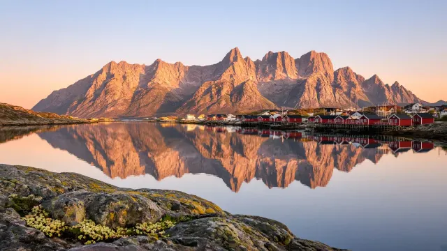 Midnight Sun Over Reinebringen and Arctic Fjord Water