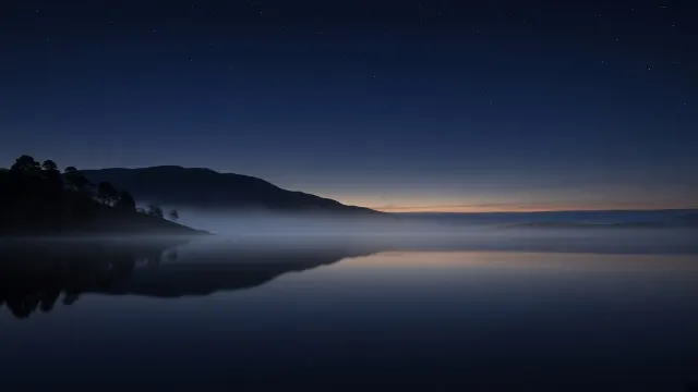 Highland Loch Shrouded in Mist Under Starlit Scottish Skies
