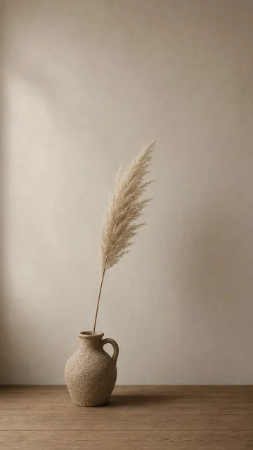 Single Ceramic Vase with Dried Pampas Grass Against Chalk Wall