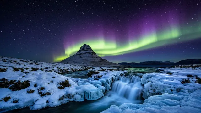 Kirkjufell Conical Peak Framed by Radiant Polar Auroral Arc