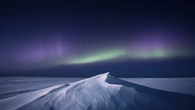 Minimalist Sastrugi Snow Wave Beneath Quiet Aurora Veil