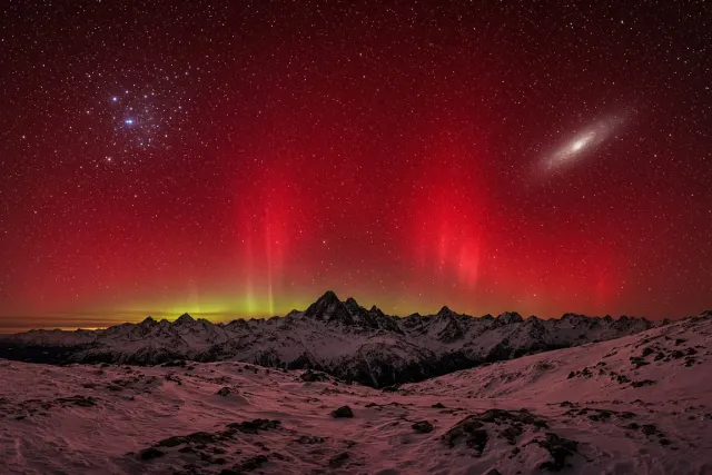 Deep Red Nitrogen Aurora Arc Above High-Altitude Ridgeline