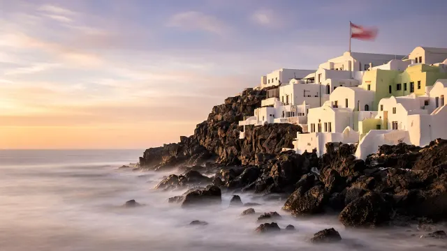 Long-Exposure Fine Art Seascape of Sculpted White Homes Above Silky Ocean Waves