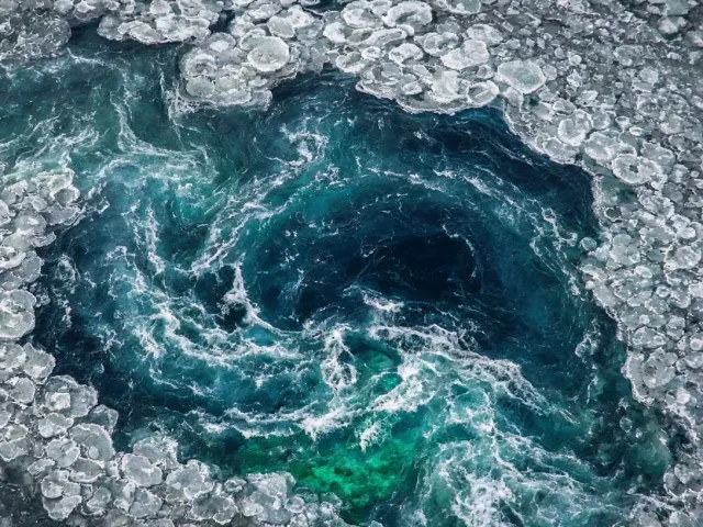 Glacial Slush Eddy in Subarctic River Rapids